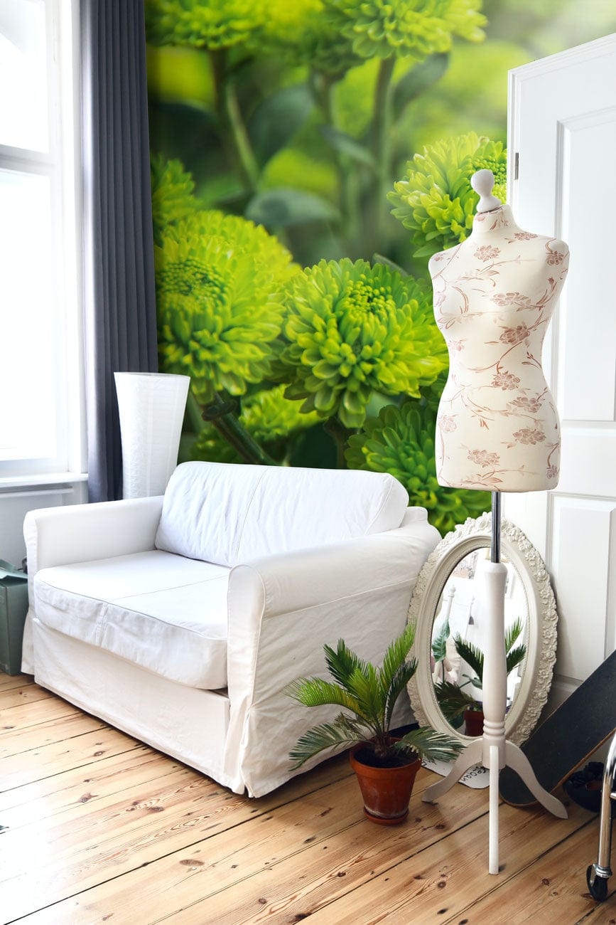 Vibrant Green Floral Botanical Mural Wallpaper with White Sofa, Wooden Flooring, Mannequin in Modern Room.