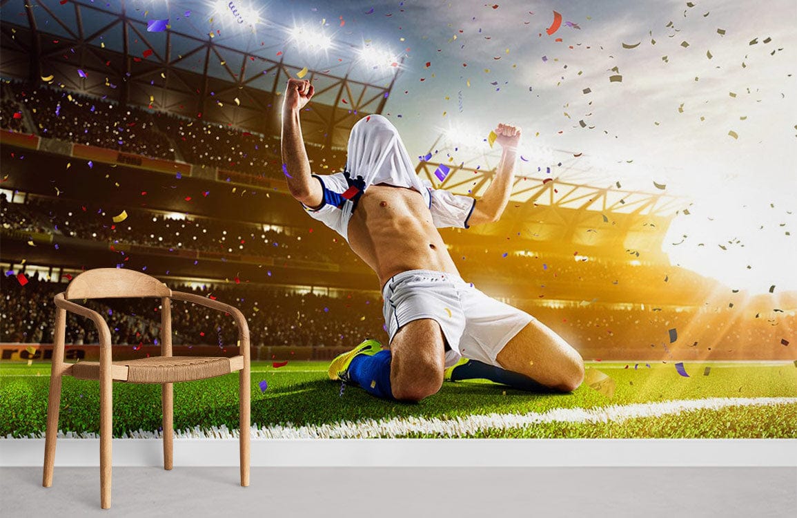 Dynamic football mural wallpaper with sporty design, wooden chair, white skirting, vibrant stadium atmosphere.