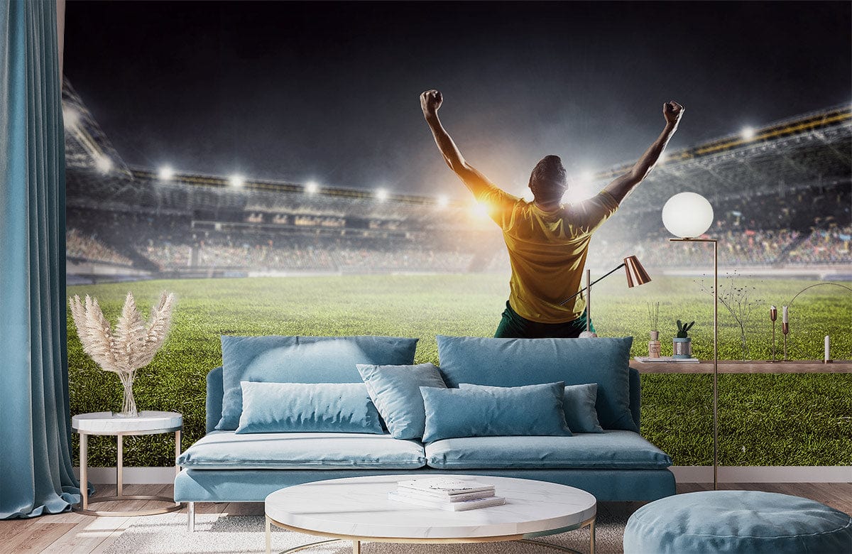 Triumphant Football Stadium Mural Wallpaper, blue sofa, light wood flooring, inspiring living room decor.