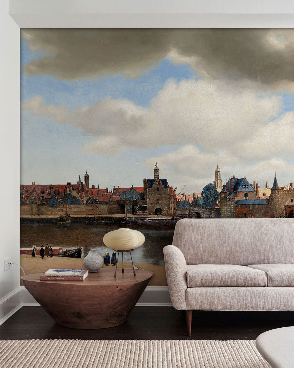 Charming Dutch Seaside Townscape Mural, pastel tones, beige sofa, wooden flooring, contemporary living room.