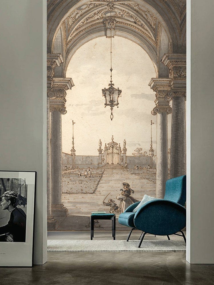 Vintage archway sepia mural wallpaper, grey walls, blue modern armchair, industrial flooring, decorative artwork.
