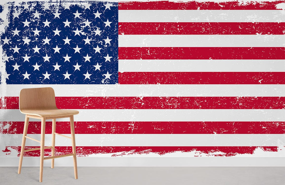 Vintage American Flag mural wallpaper with distressed design, featuring light wood chair, grey flooring.