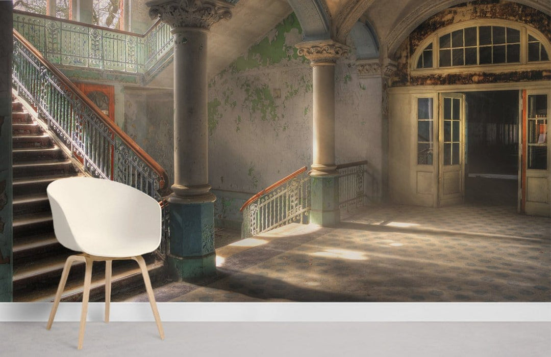 Vintage Elegance Grand Staircase Mural Wallpaper; rustic charm, white chair, neutral flooring, spacious room.