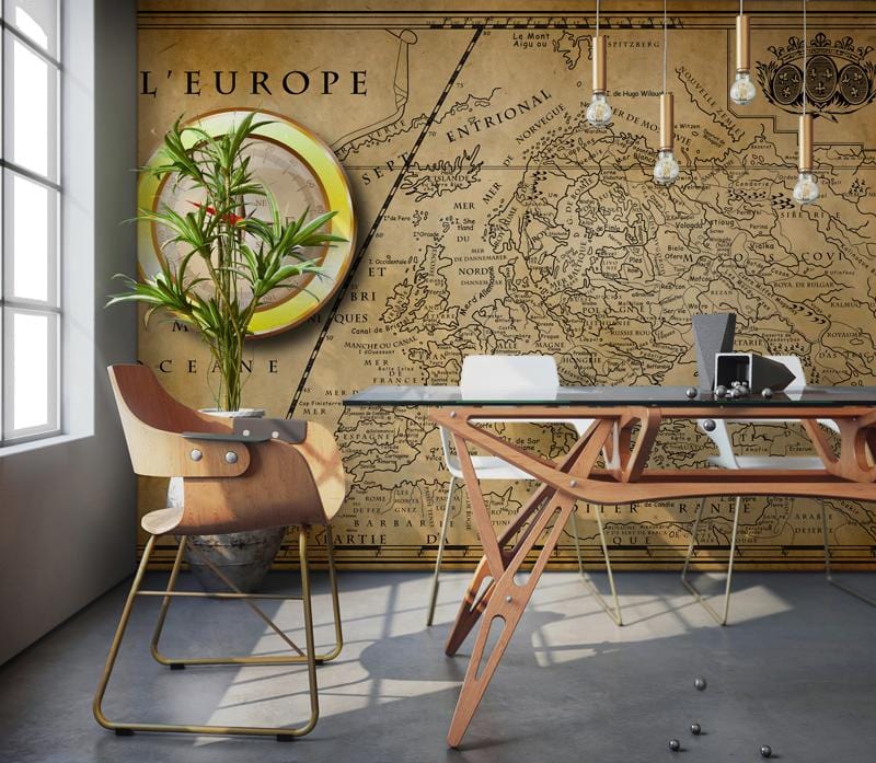 Vintage European map mural wallpaper with antique nautical design, featuring modern chairs, glass table, pendant lights.