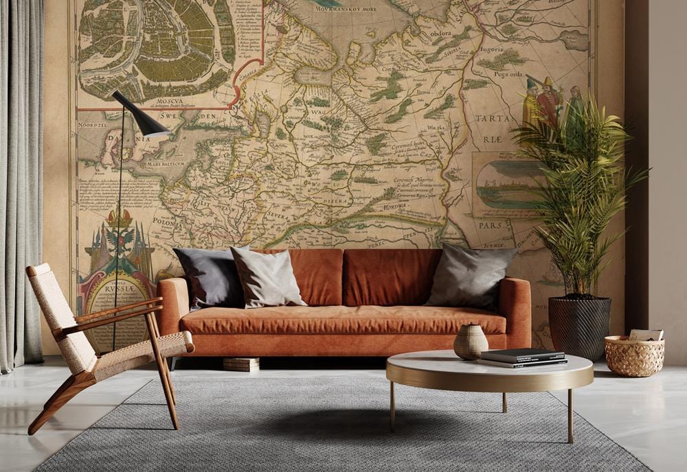 Vintage Antique Map Mural Wallpaper in beige; features brown sofa, grey rug, wicker chair.