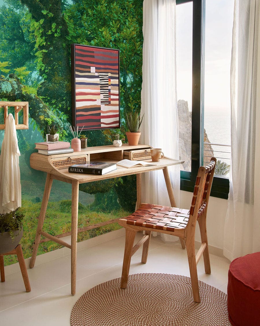 Enchanted Misty Forest Green Nature Mural Wallpaper, wooden desk, woven chair, cosy reading nook.