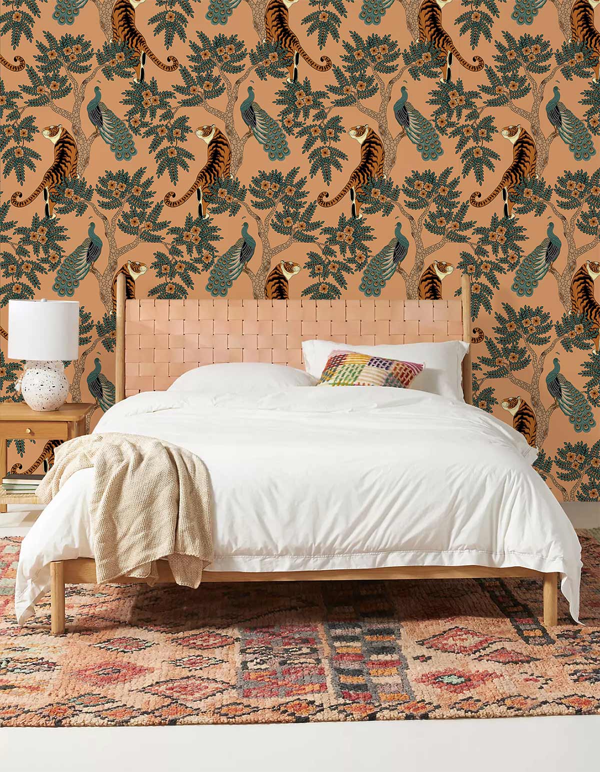 Tropical Tiger and Peacock Mural Wallpaper in earthy tones, featuring bedroom with woven headboard.