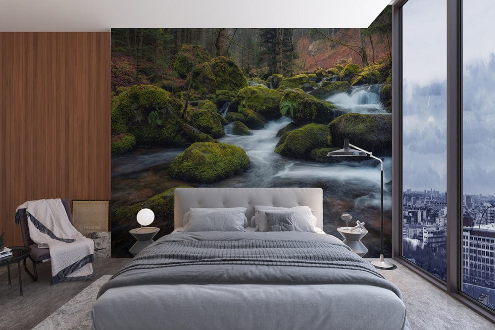 Mystical Forest Stream Wallpaper in modern bedroom; grey bed, wood panel wall, city view windows.