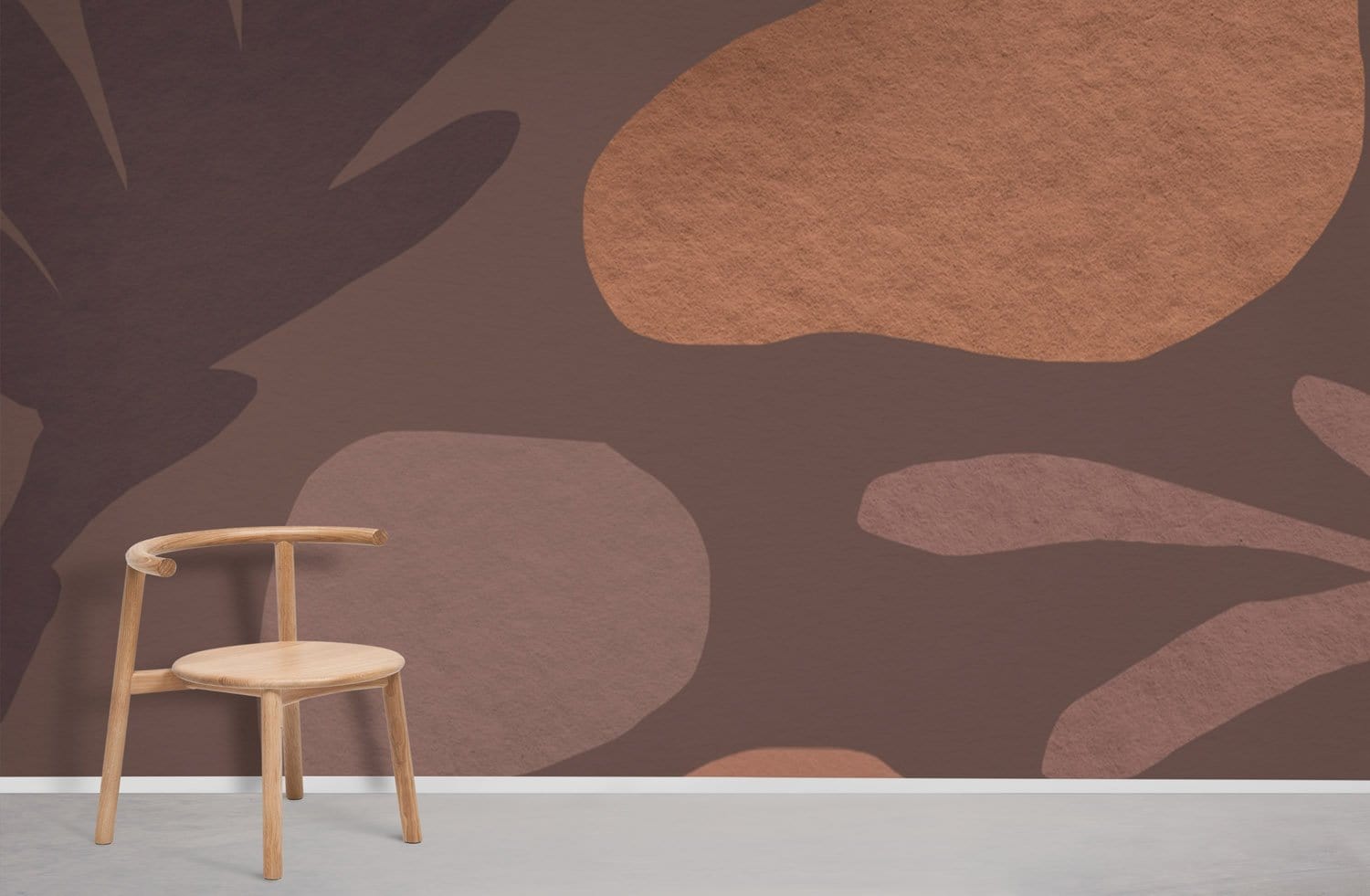 Modern interior with brown abstract leaf wallpaper, light wooden chair, and grey concrete floor.