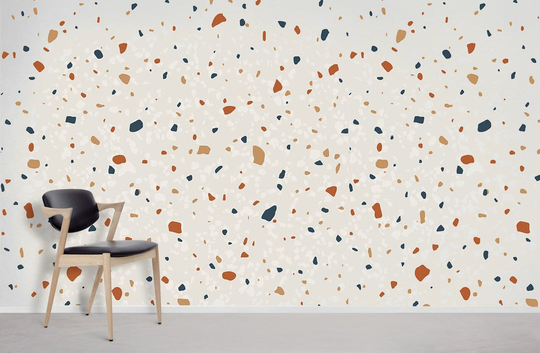 Modern terrazzo wallpaper with orange and navy accents, retro design; stylish black chair, concrete flooring.