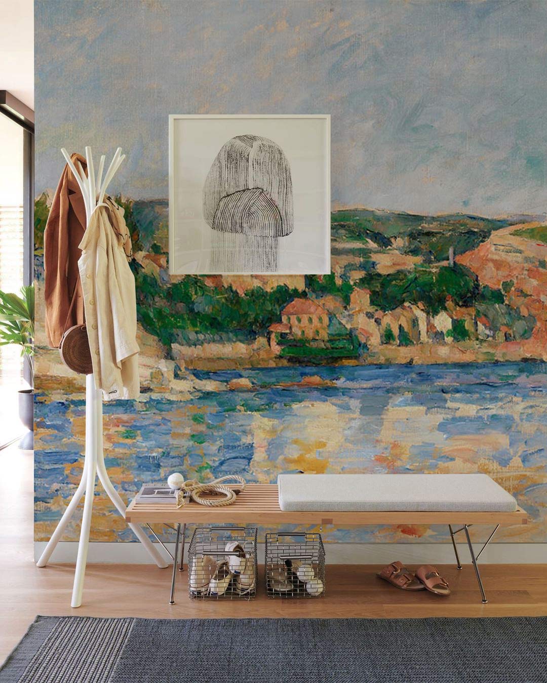 Impressionist coastal wallpaper in serene blues; modern hallway with coat rack, bench, and wooden flooring.
