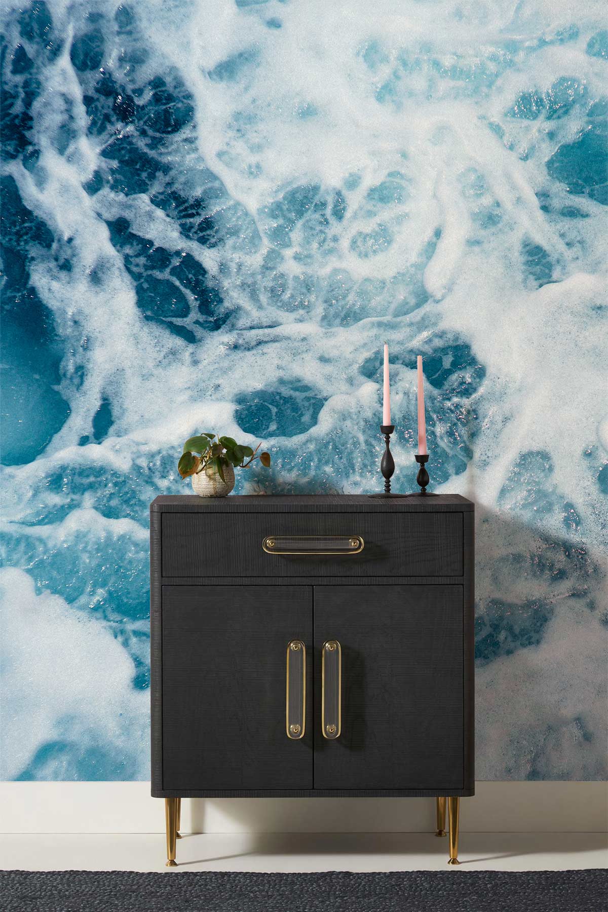 Refreshing Ocean Wave Mural Wallpaper in blue with modern dark sideboard on textured flooring.