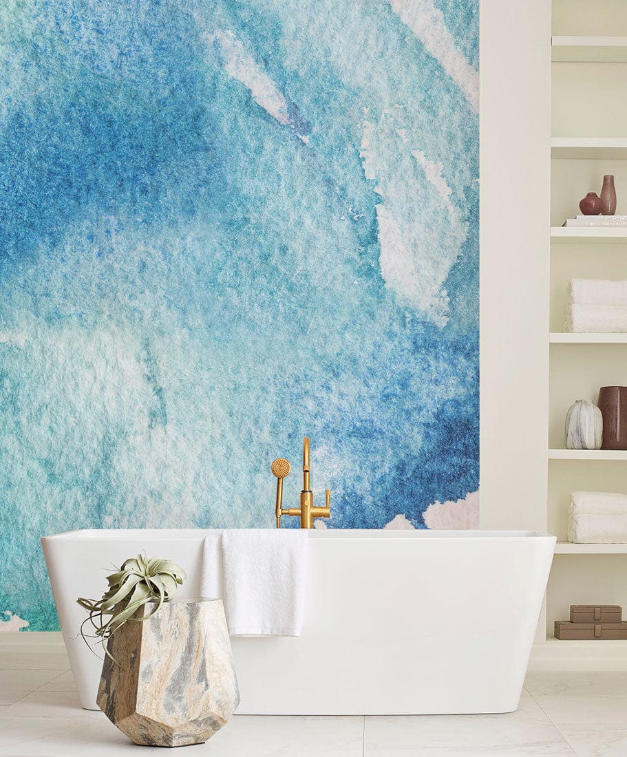 Blue watercolour abstract mural wallpaper with freestanding bathtub, white shelves, modern bathroom decor.