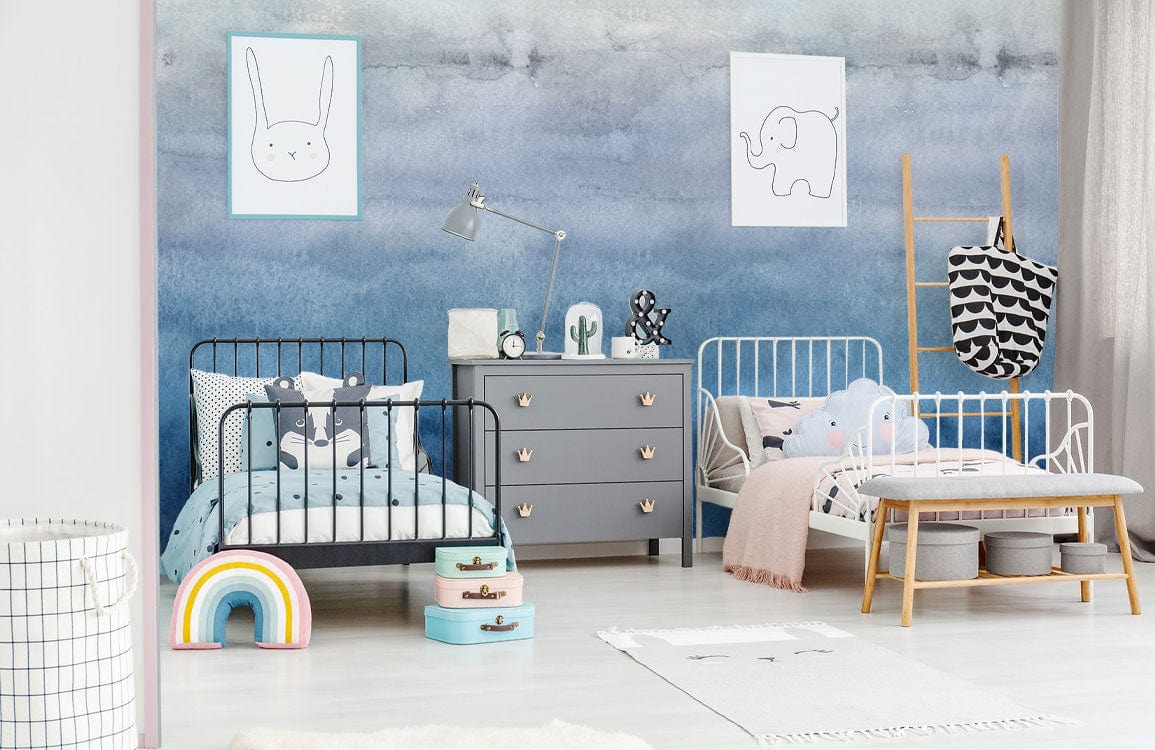Blue Ombre Watercolour Gradient Mural Wallpaper in children's room; metal beds, grey dresser, light flooring.