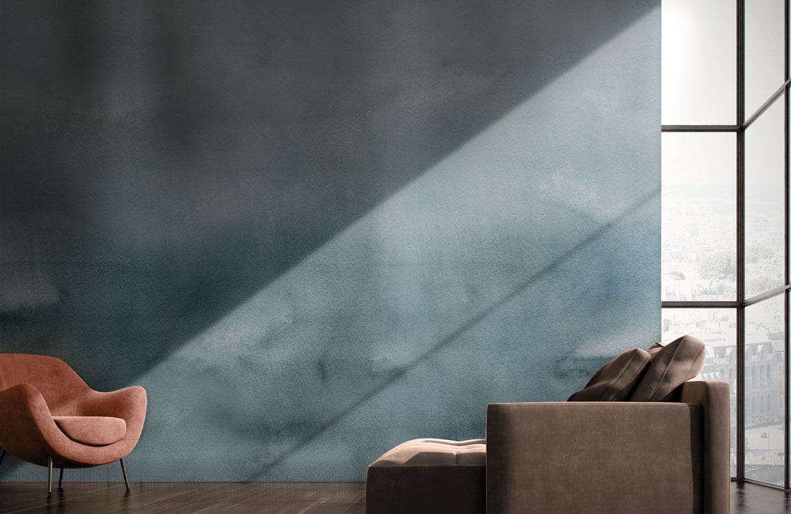Mural wallpaper featuring misty blue ombre landscape; brown modern sofa; dark wood flooring; armchair.