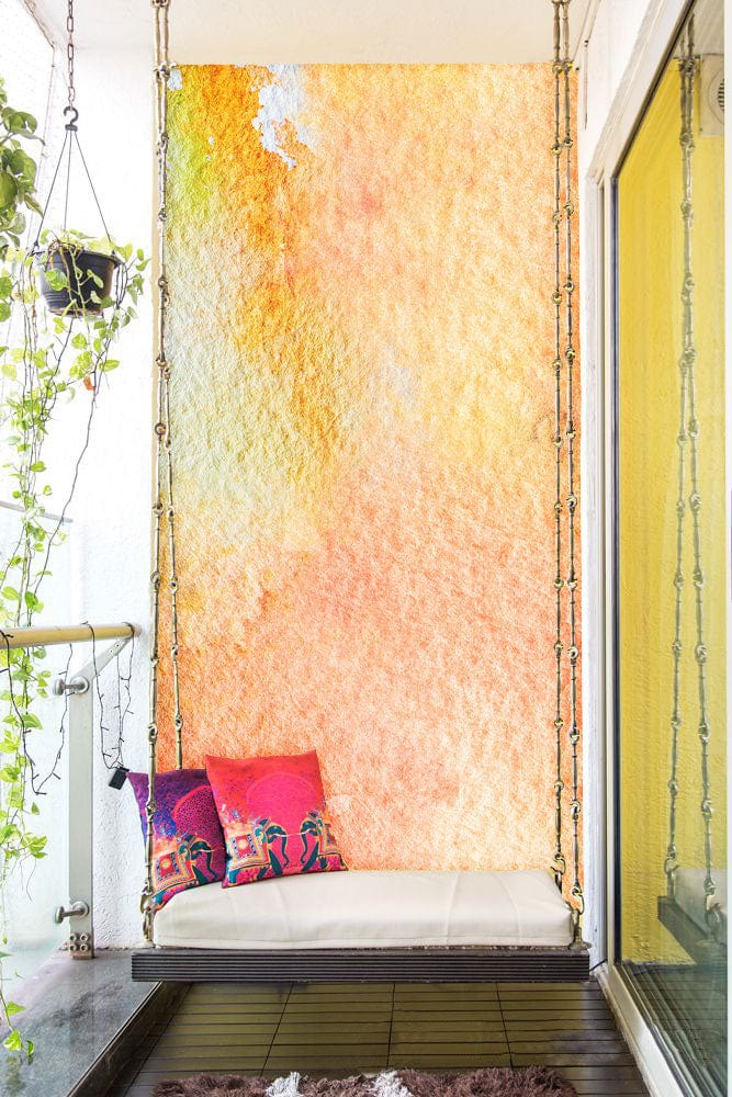 Soft Pastel Watercolour Abstract Mural Wallpaper in Earthy Tones on balcony with swing seat, cushions.