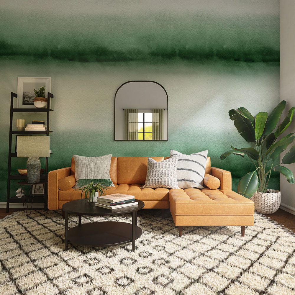 Green Ombre Watercolour Stripes Mural Wallpaper with orange sofa, contemporary rug, and decorative mirror.