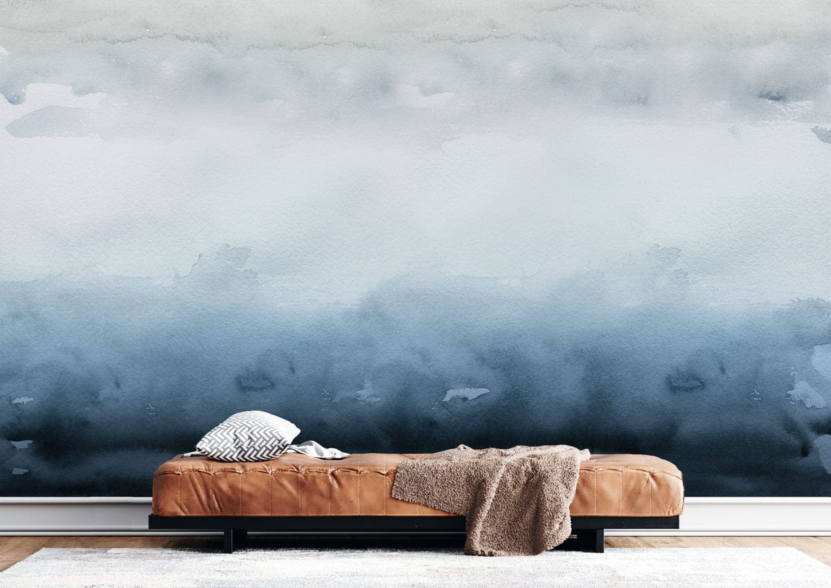 Tranquil Misty Blue Watercolour Ombre Wallpaper enhances serene interiors, featuring brown leather sofa, light wood flooring.