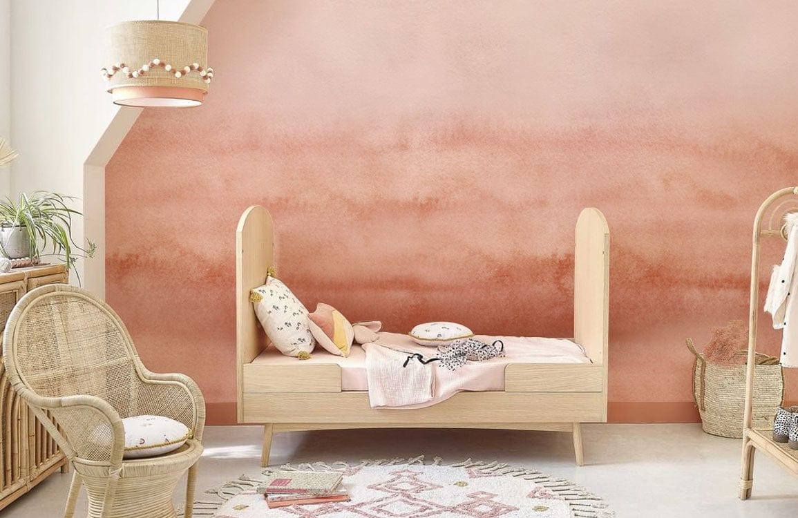 Elegant Watercolour Blush Gradient Wallpaper in children's room featuring neutral decor and rattan furniture.