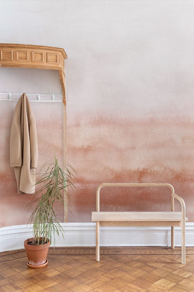 Elegant watercolour blush gradient mural; neutral hues, wooden bench, parquet flooring, hallway decor.