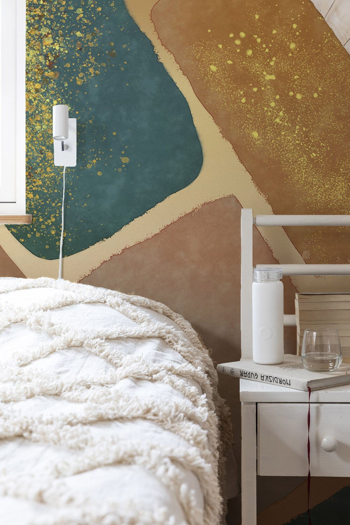 Abstract Earthy Tones Geometric Mural Wallpaper with gold accents in cosy bedroom, white bed.