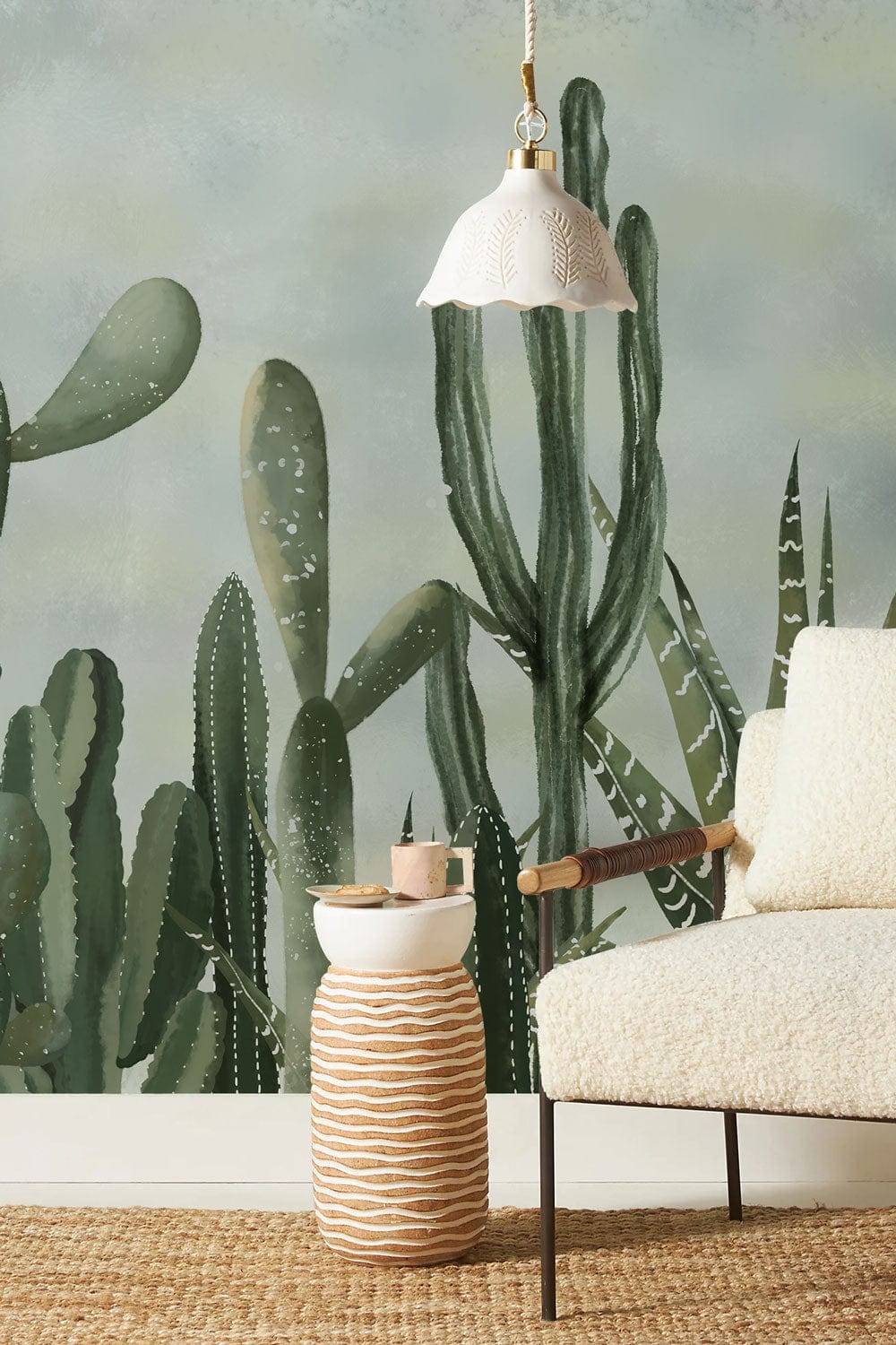 Elegant green cactus mural wallpaper with cosy armchair, pendant light, and woven rug in living room.