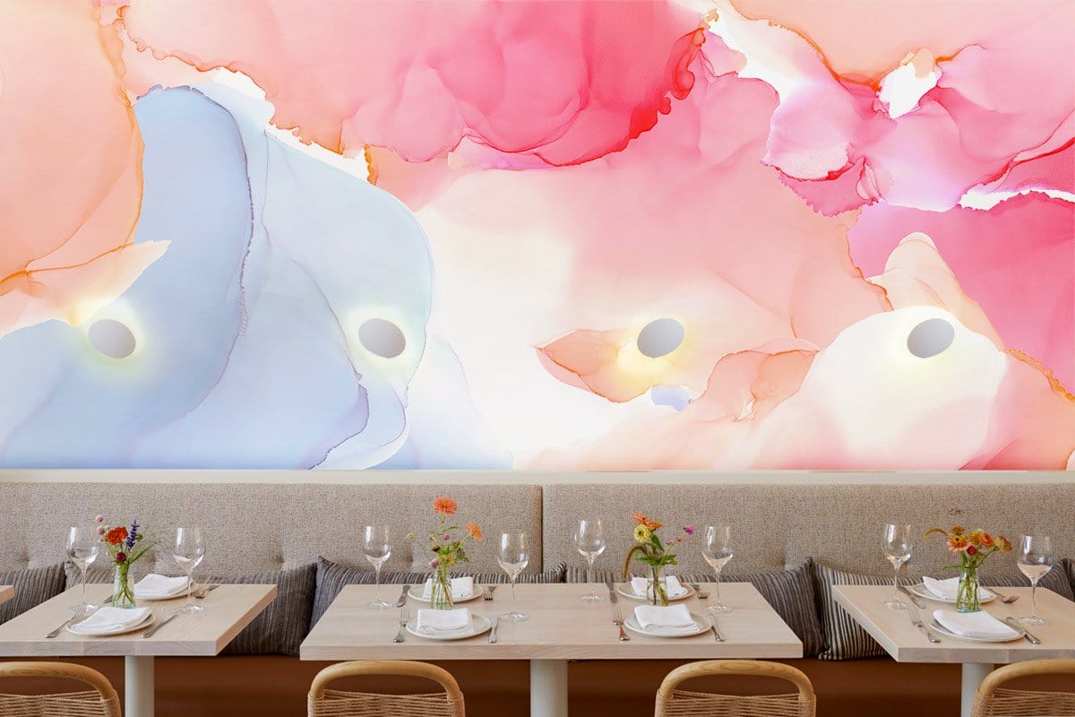 Dining area with abstract pastel mural wallpaper in pink and blue, wooden chairs, and neutral seating.