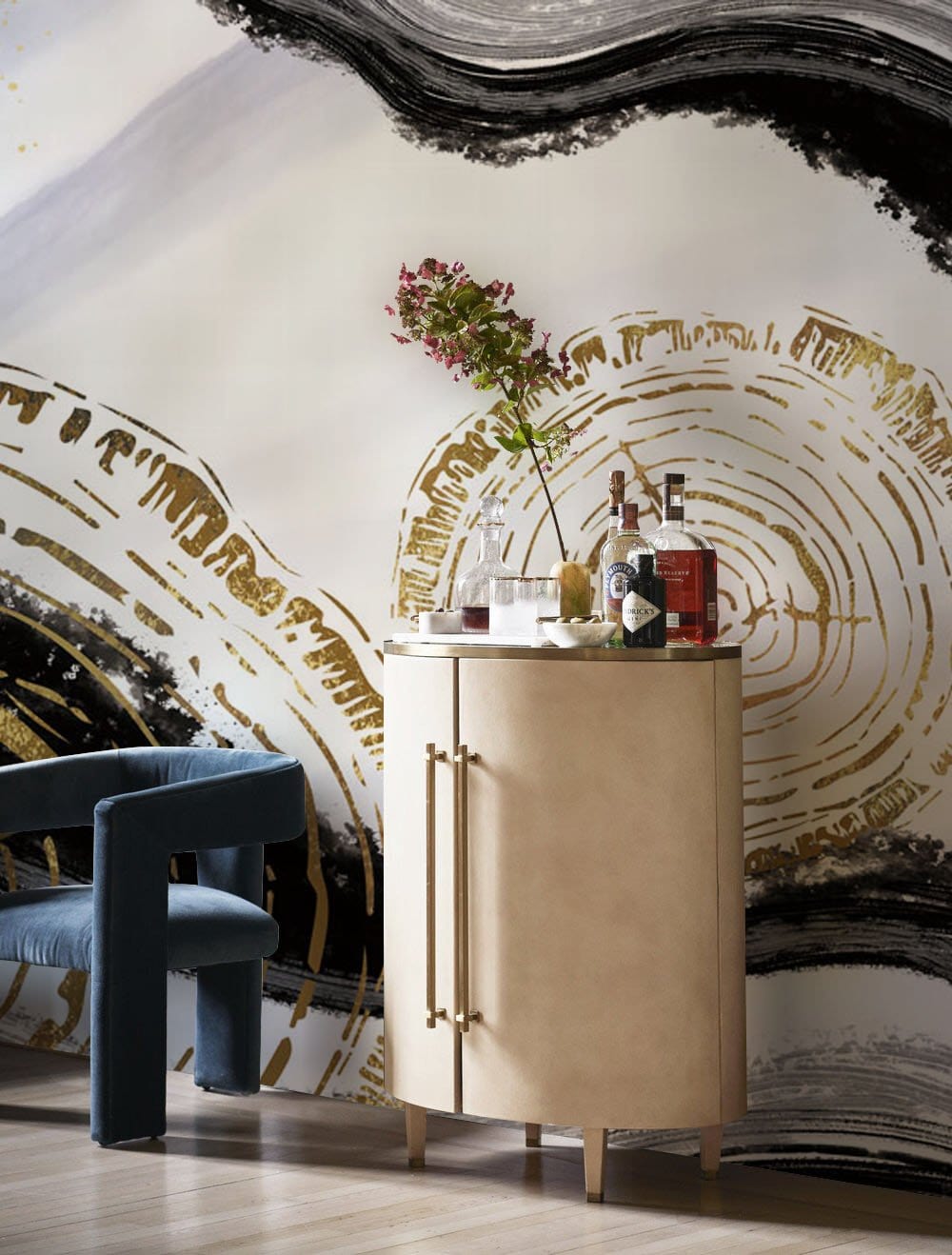 Elegant Gold and Black Abstract Tree Rings Mural Wallpaper Art with blue chair and beige cabinet.