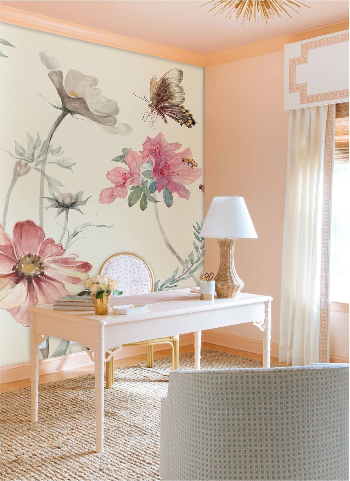 Vintage pastel floral butterfly mural wallpaper in peach-walled office with woven rug and elegant desk.