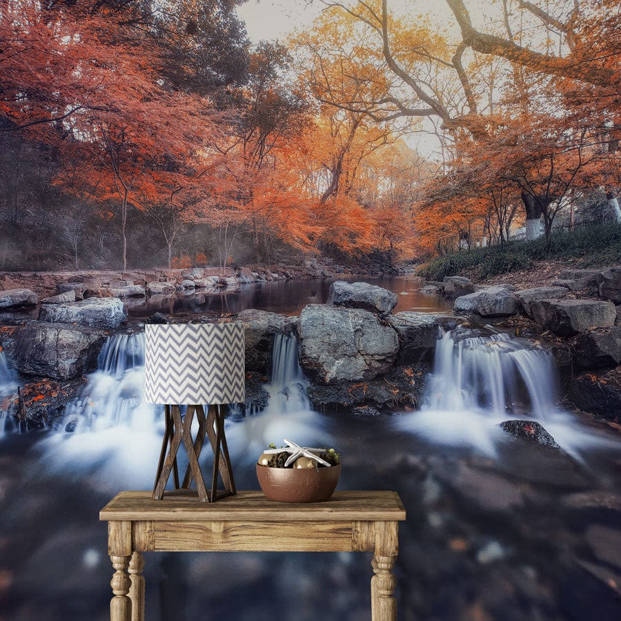 Mural wallpaper featuring an autumn stream; natural wood table. Autumn Serenity Stream Landscape Mural.