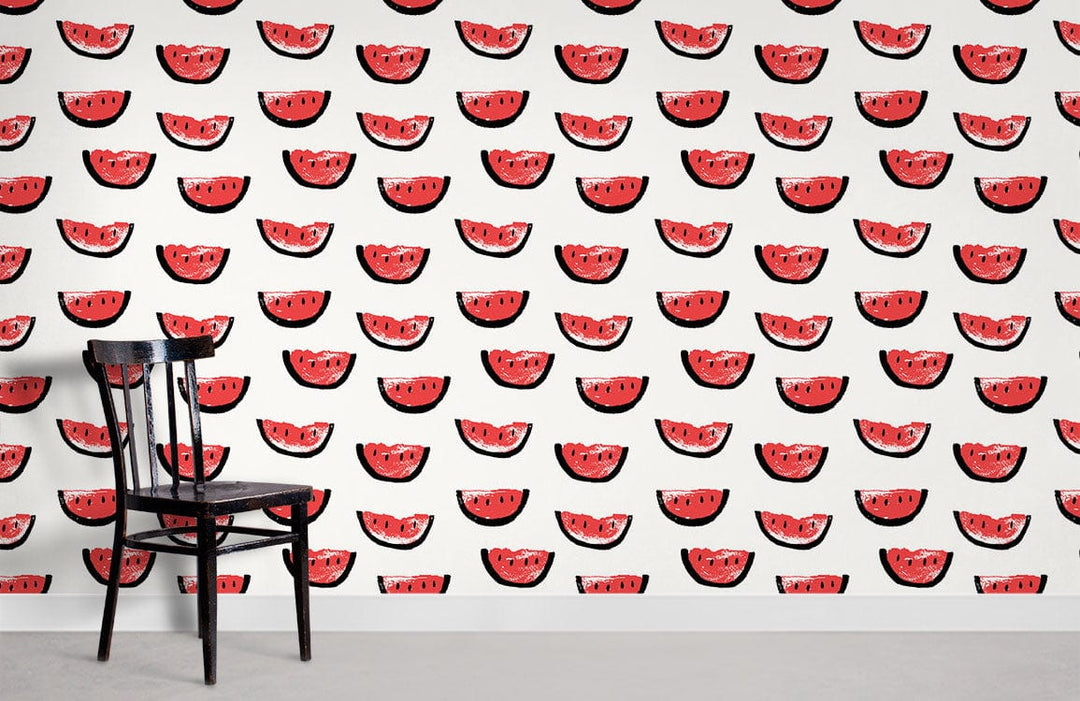 Playful red watermelon pattern wallpaper with black chair, perfect for vibrant summer room interiors.