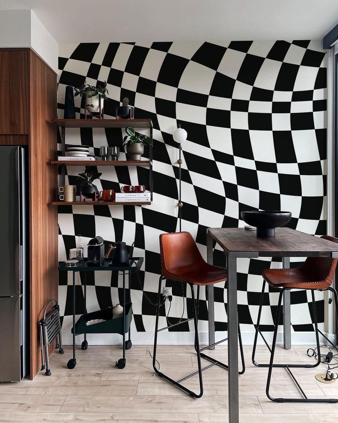 Monochrome wavy wallpaper, wooden shelving, brown barstools, industrial table, modern kitchen space.