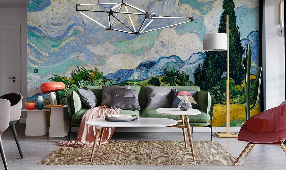 Vibrant landscape mural wallpaper in stylish living room; green sofa, modern lighting, and wooden flooring.