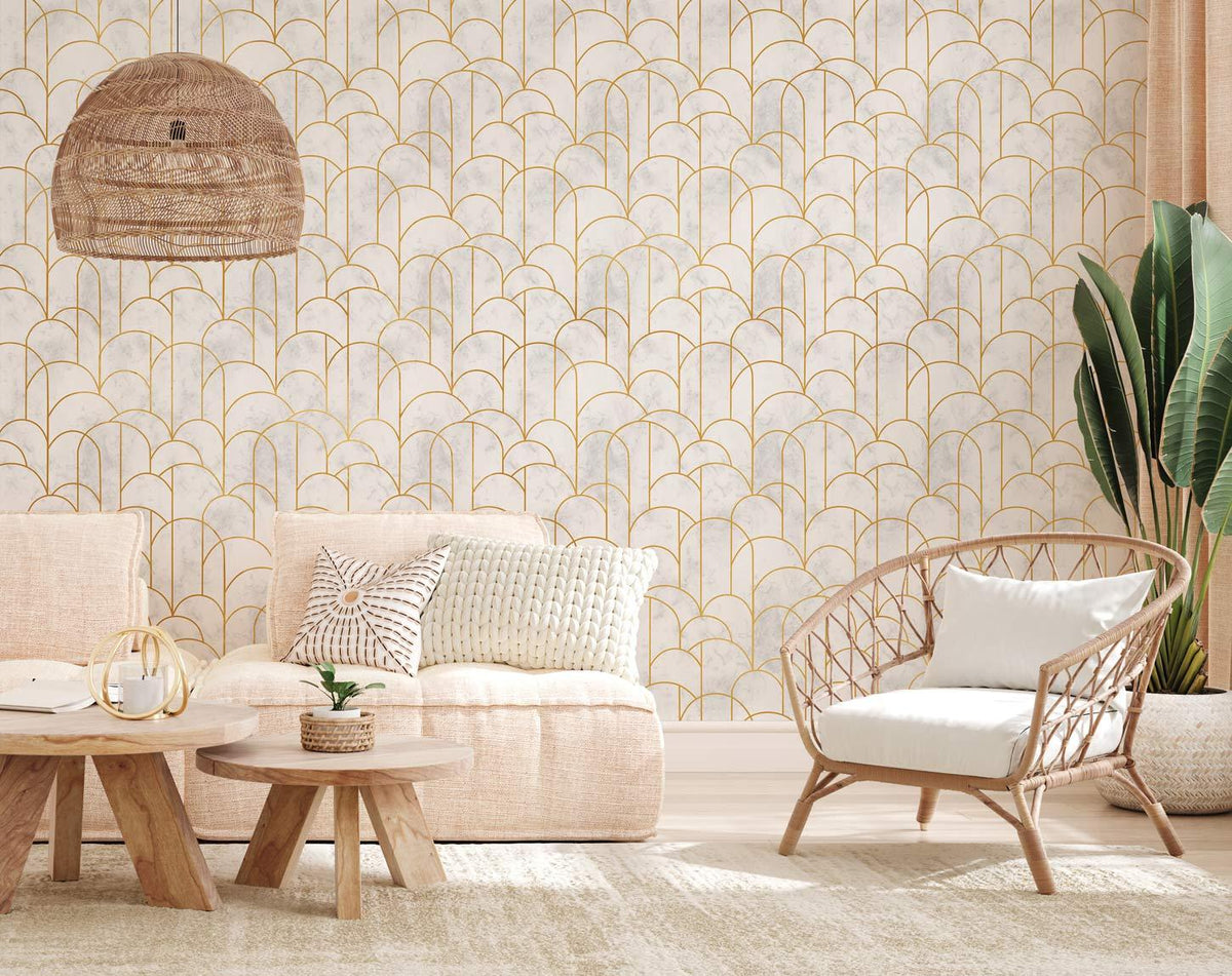 Art Deco gold scallop wallpaper in living room, beige sofa, wicker chair, neutral rug flooring.