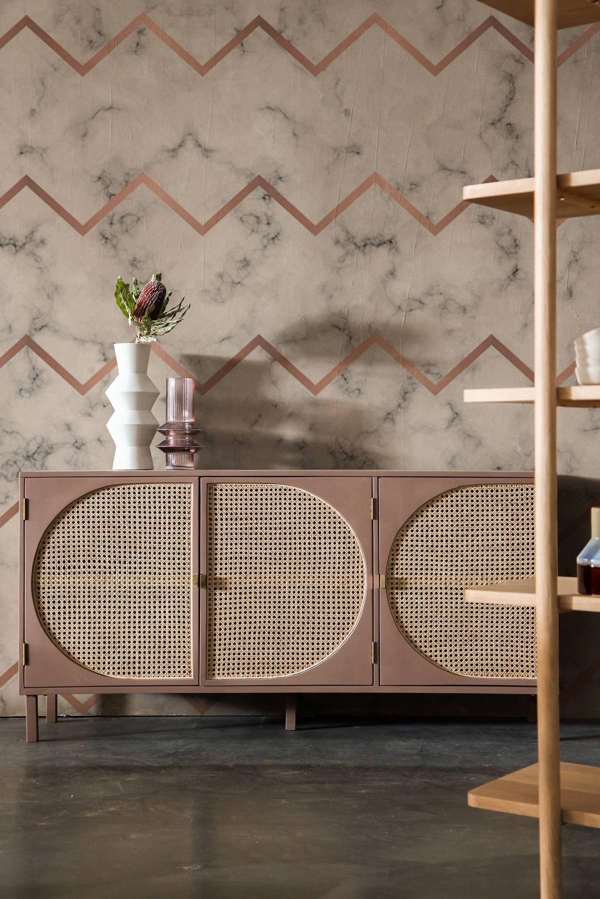 Marble chevron glam wall mural with rose gold; elegant sideboard, grey flooring in stylish living room.