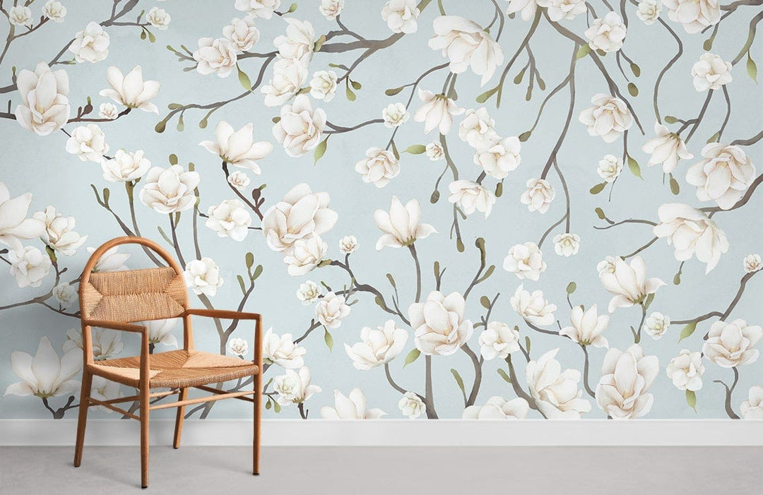 Serene Blue Magnolia Blossom Wallpaper in a living room with rattan chair, grey floor, floral design.