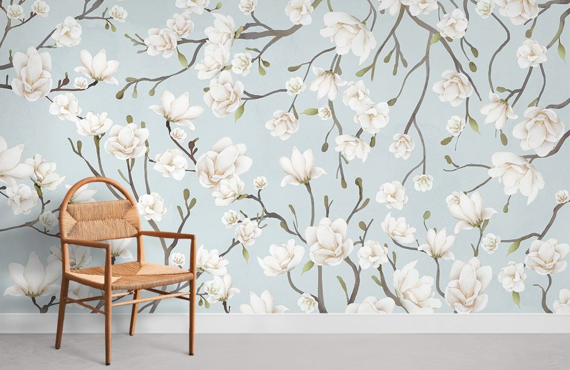 Serene Blue Magnolia Blossom Wallpaper in a living room with rattan chair, grey floor, floral design.