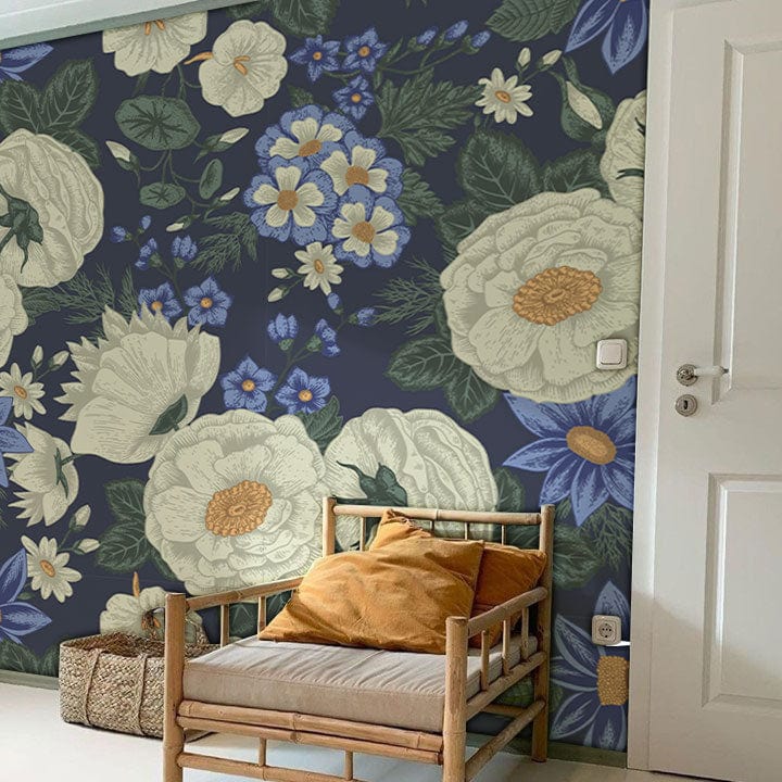 Midnight Blue Floral Elegance vintage botanical wallpaper with cream blooms, natural wicker chair, white door.