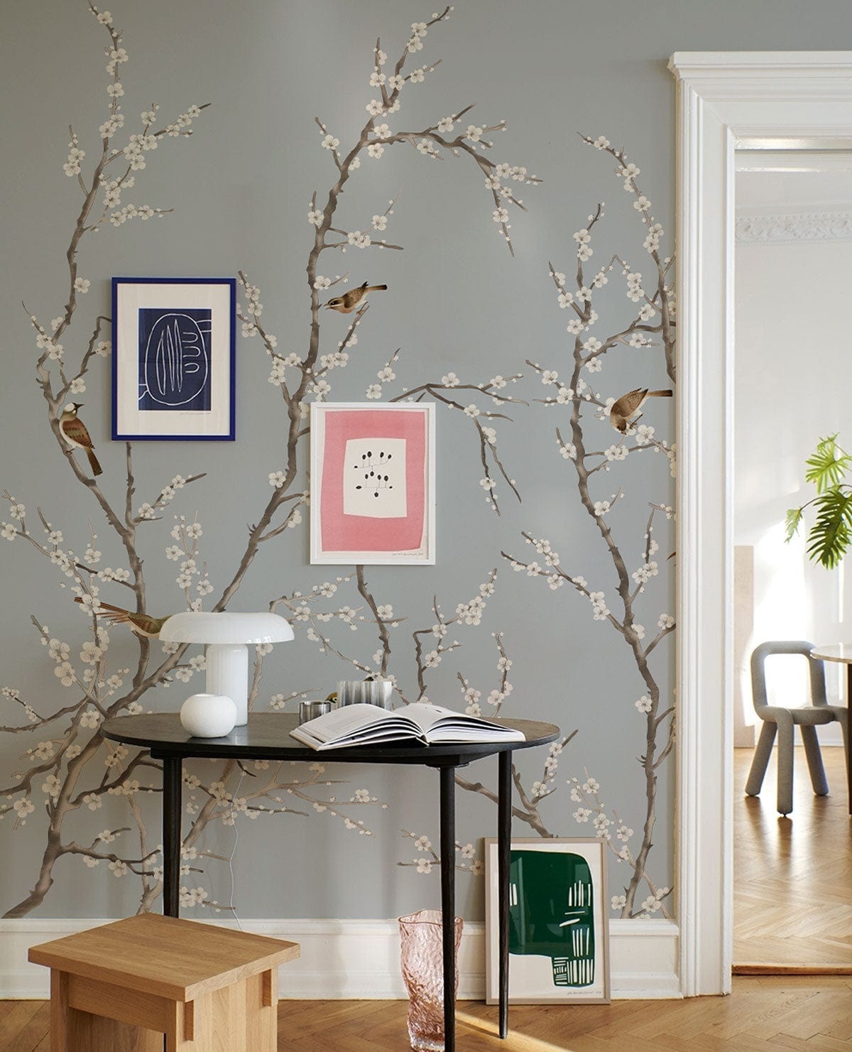 Elegant Blue Bird Blossom Branches Mural Wallpaper in living room with parquet flooring and modern decor.