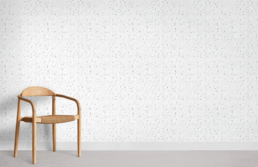 Minimalist white speckled wallpaper; wood chair; modern elegant home decor; light grey flooring.