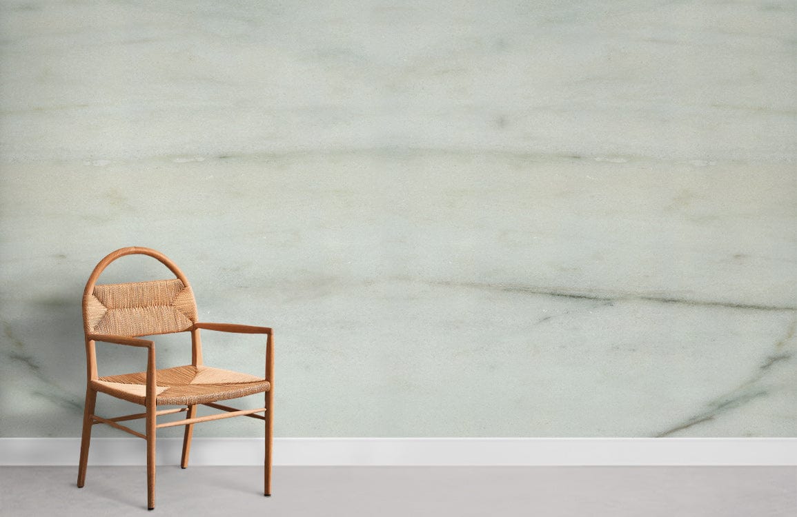 Elegant marble effect wallpaper in cream and grey tones with wicker chair, white skirting board.