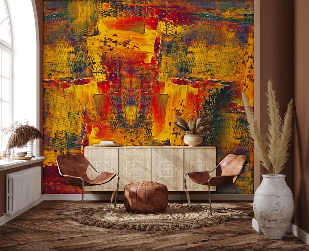 Vibrant mural with red and gold hues, featuring leather chairs, wooden flooring, and modern decor.