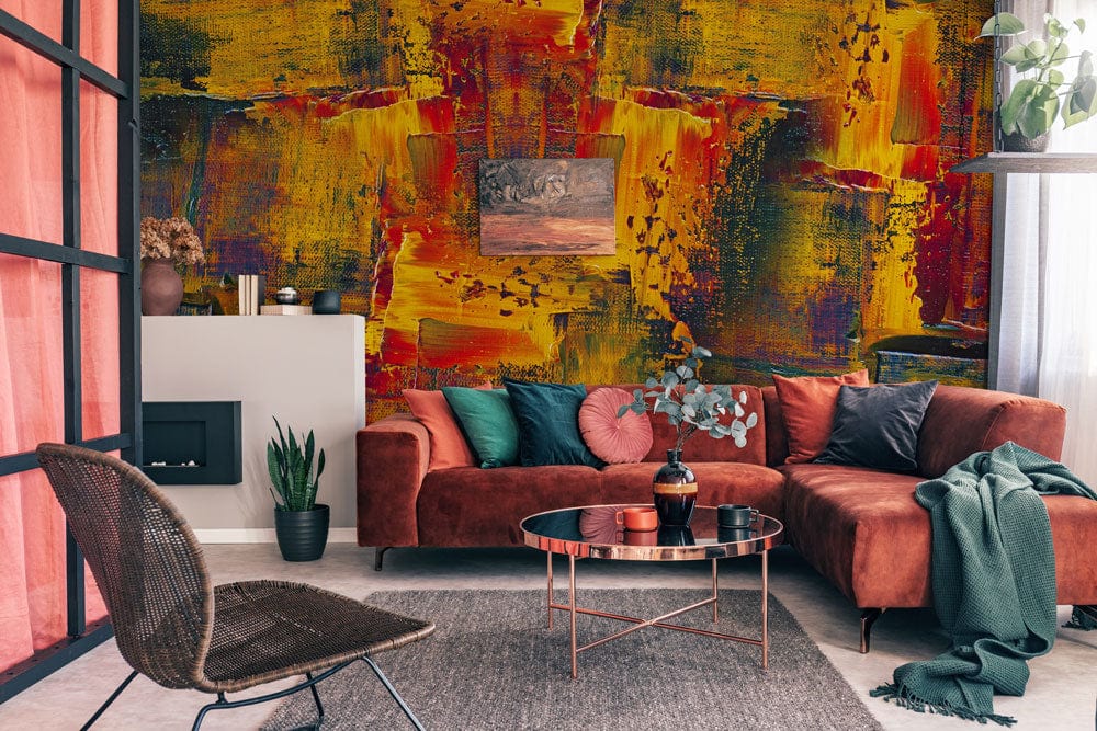Vibrant abstract brushstroke mural wallpaper with red sectional sofa in stylish living room interior.