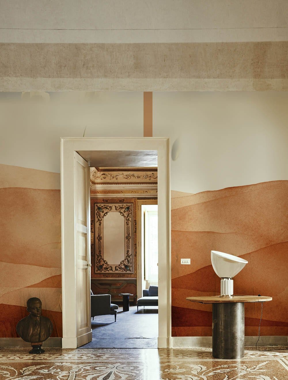 Terracotta Desert Landscape Mural Wallpaper; minimalist room, sandy tones, ornate flooring, earthy decor.