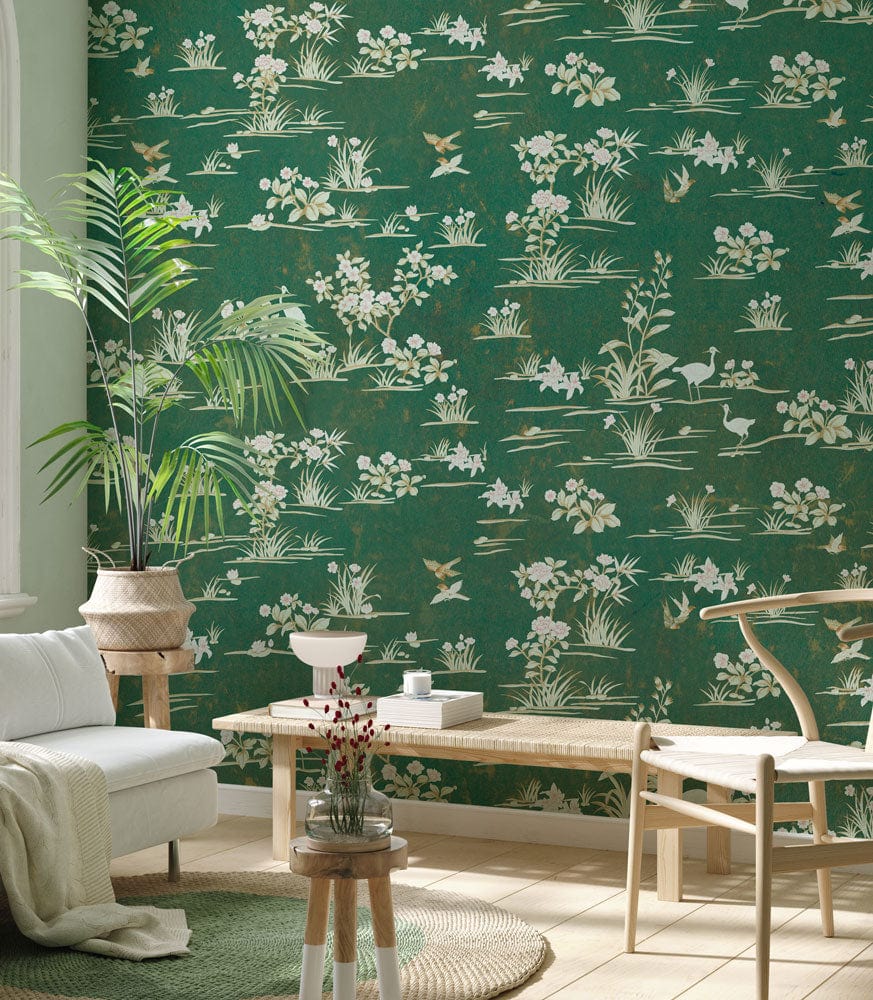 Vintage green floral wallpaper in living room with white sofa, beige chair, wooden flooring, indoor plant.