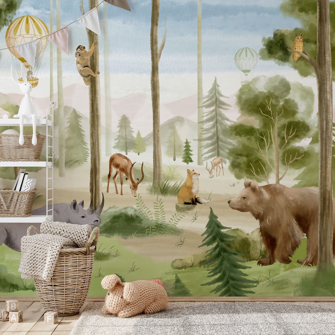 Scenic forest animal mural wallpaper with wicker basket, plush carpet, and neutral nursery setting.
