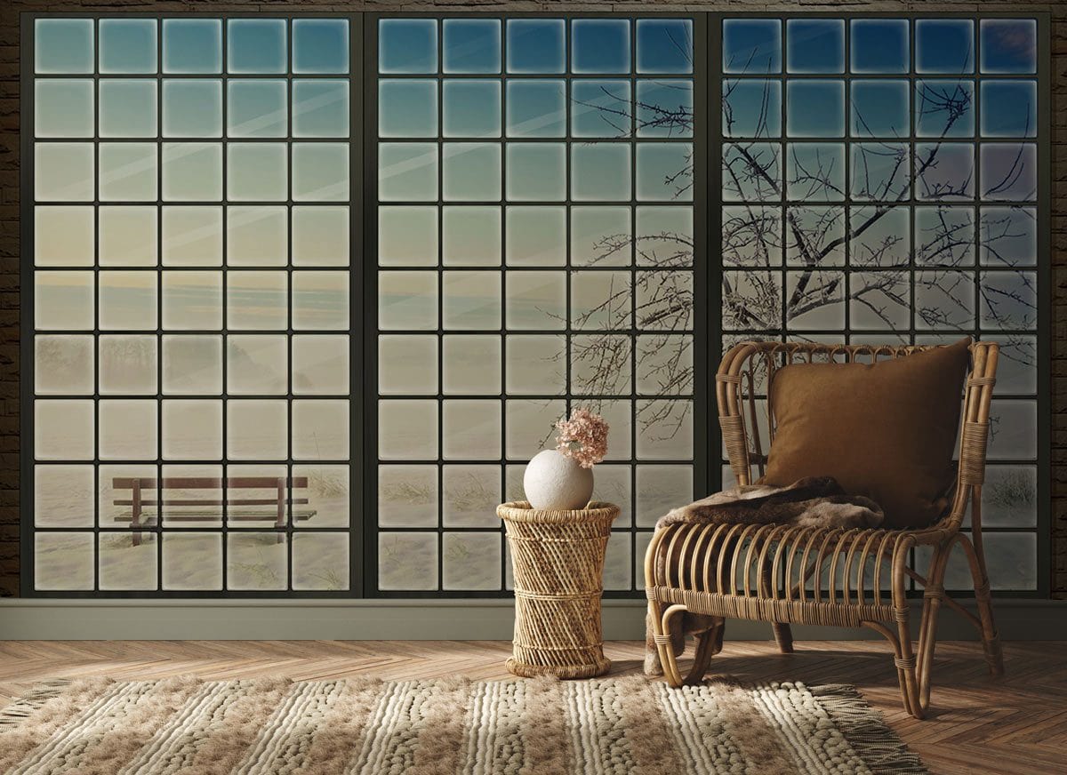Winter Serenity Frosted Window Mural Wallpaper in cosy lounge, wicker chair, striped rug, wooden flooring.