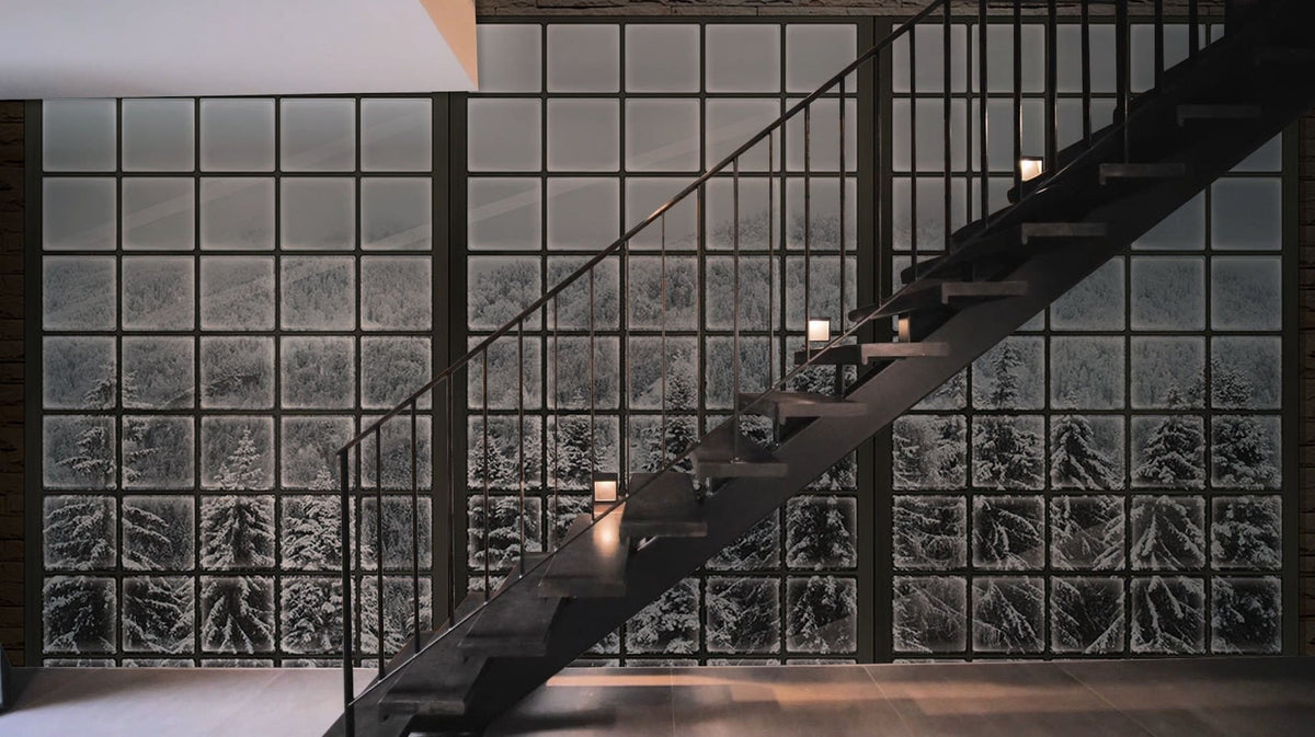 Panoramic Winter Wonderland Mural Wallpaper, snowy forest, modern staircase, minimalist interior, dark flooring.