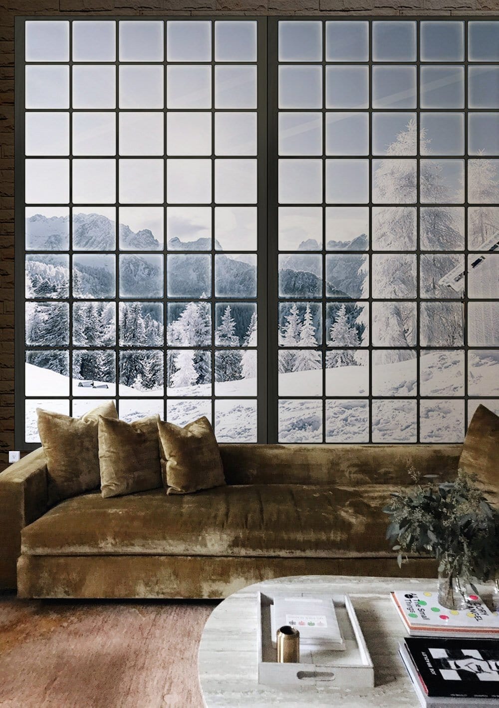 Winter Wonderland mural wallpaper, brown velvet sofa, light wood flooring, cosy living room setting.