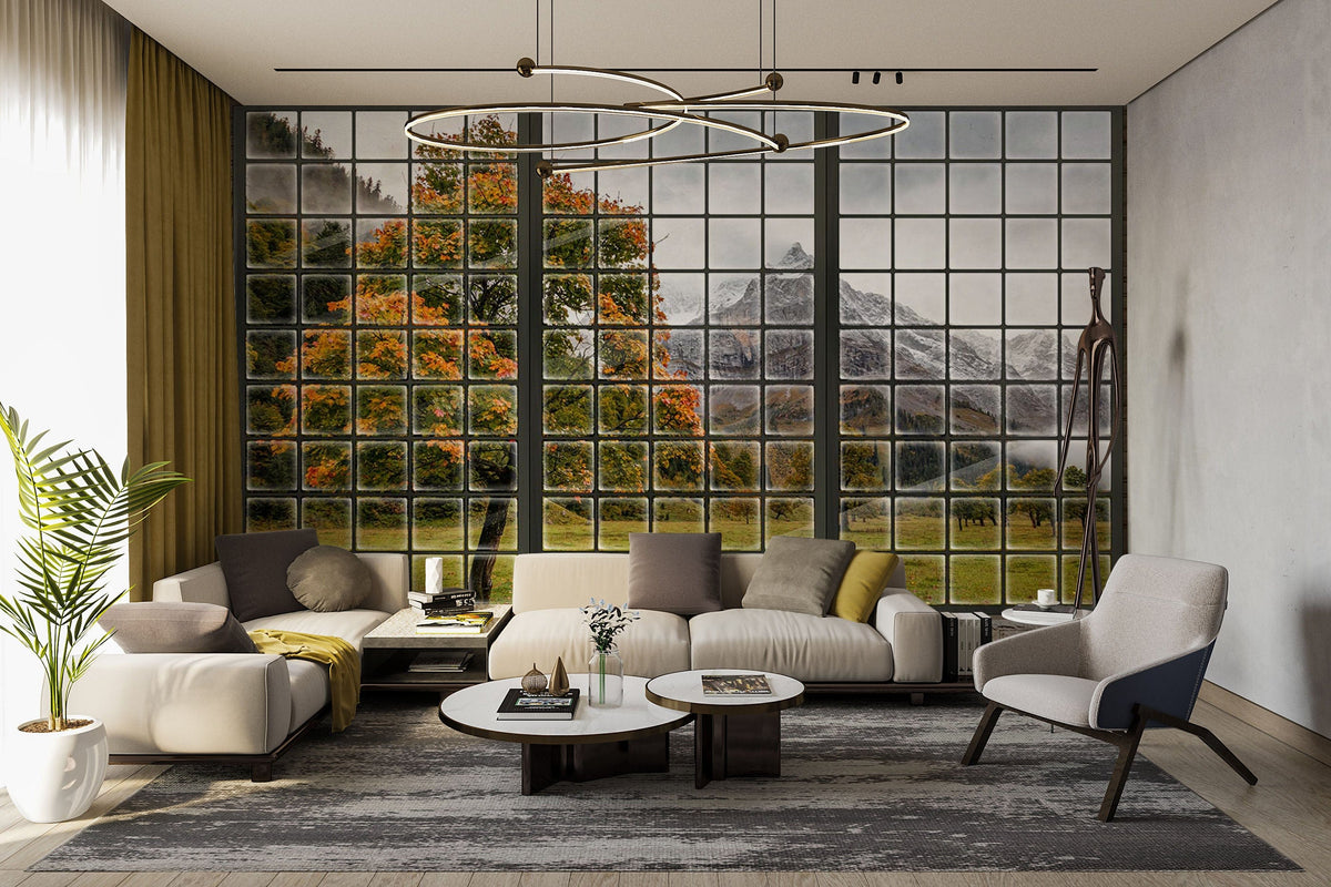 Scenic Mountain Autumn mural with taupe sofa, grey armchair, modern chandelier, and hardwood floor in lounge.